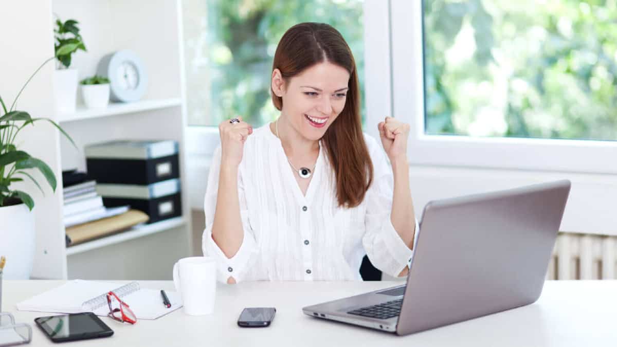 Woman happy looking at laptop